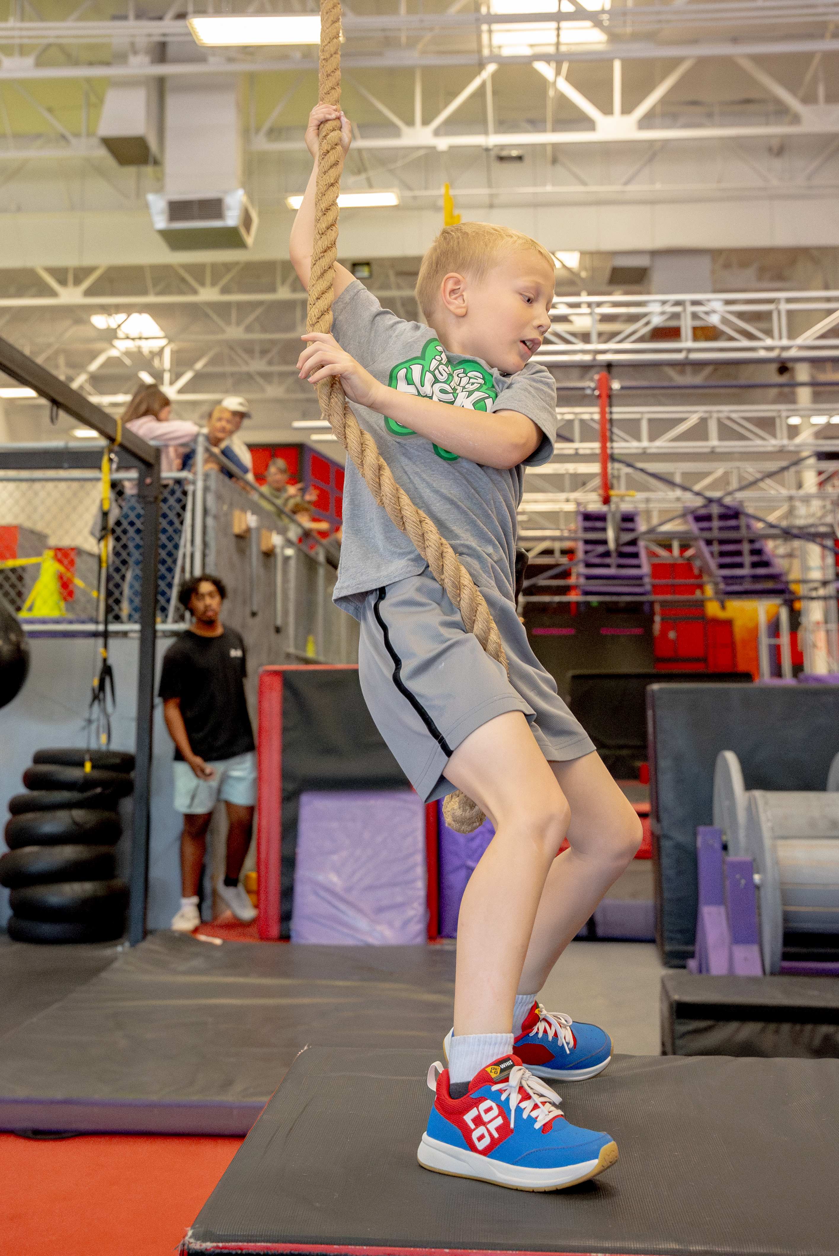 NES athlete on rope swing wearing Ollo shoes at competition